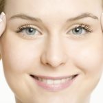 Smiling woman with clear skin from chemical peels.
