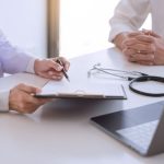 Physician meeting with a patient and going over their results