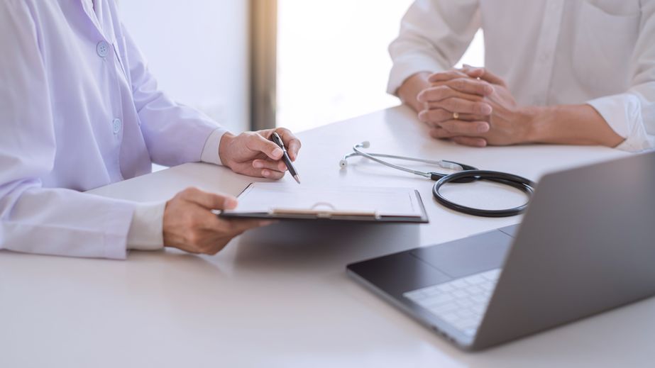 Physician meeting with a patient and going over their results