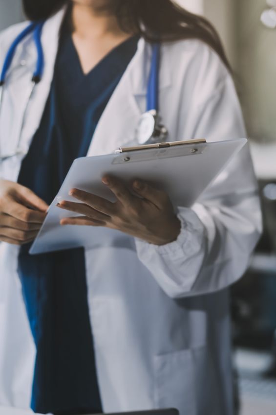 Portrait of a female US Civil Surgeon looking at a patient's chart.