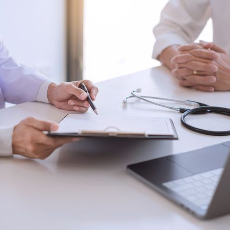 Physician meeting with a patient and going over their results