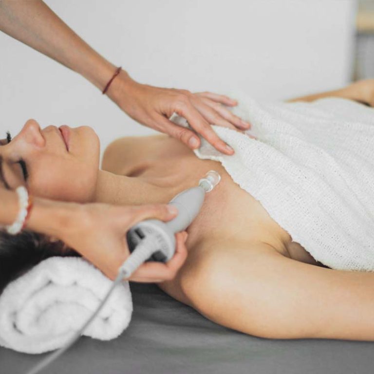 Woman receiving laser treatment at a cosmetic clinic